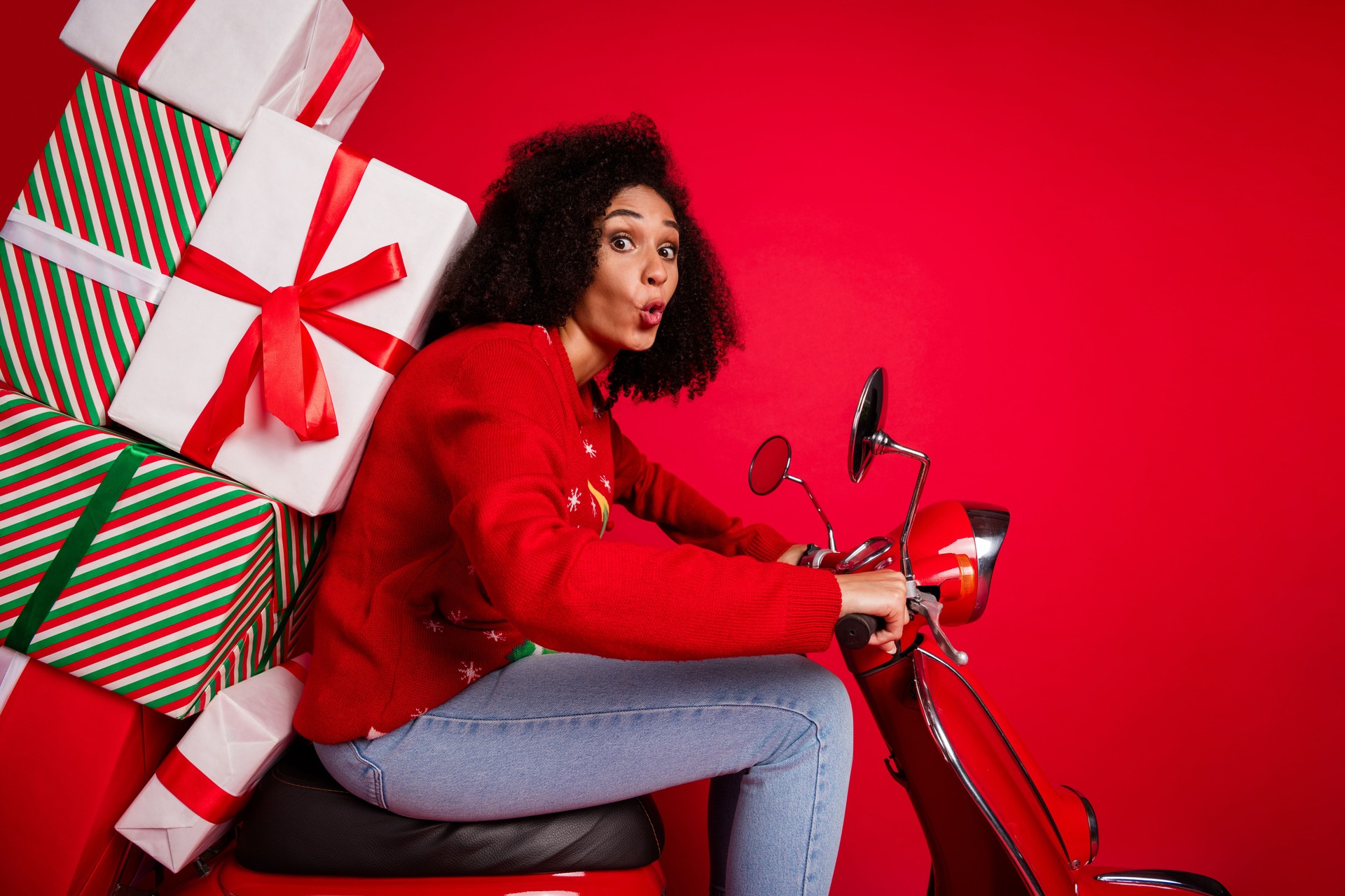 Photo of lovely amazed cute girl driving moped delivering gifts magic miracle time isolated on red color background